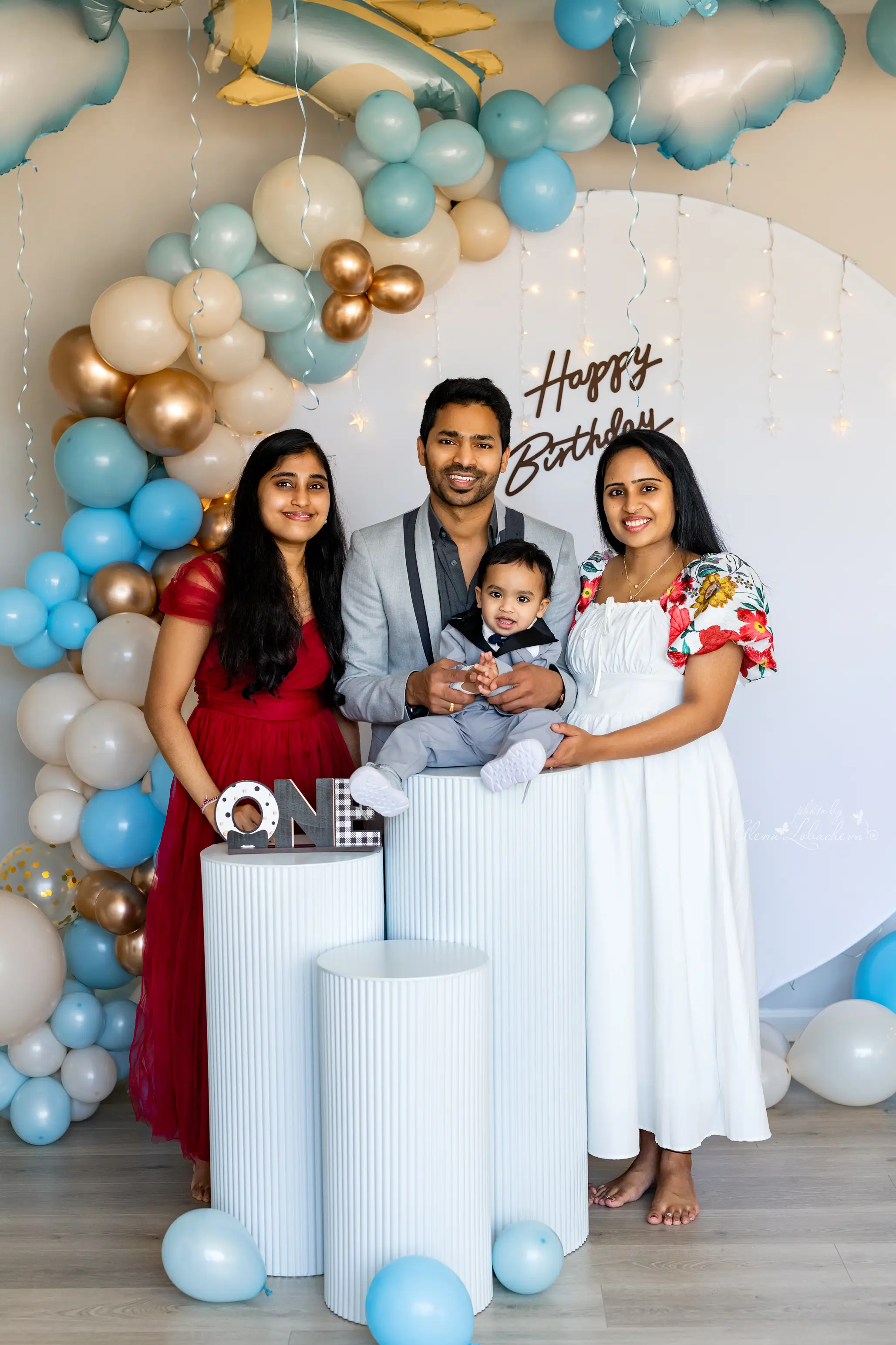 Family gathered at a blue and gold first birthday celebration