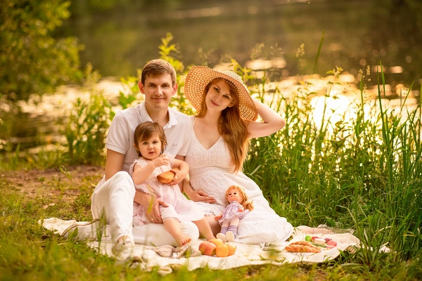 Family enjoying a summer picnic portrait in warm evening light