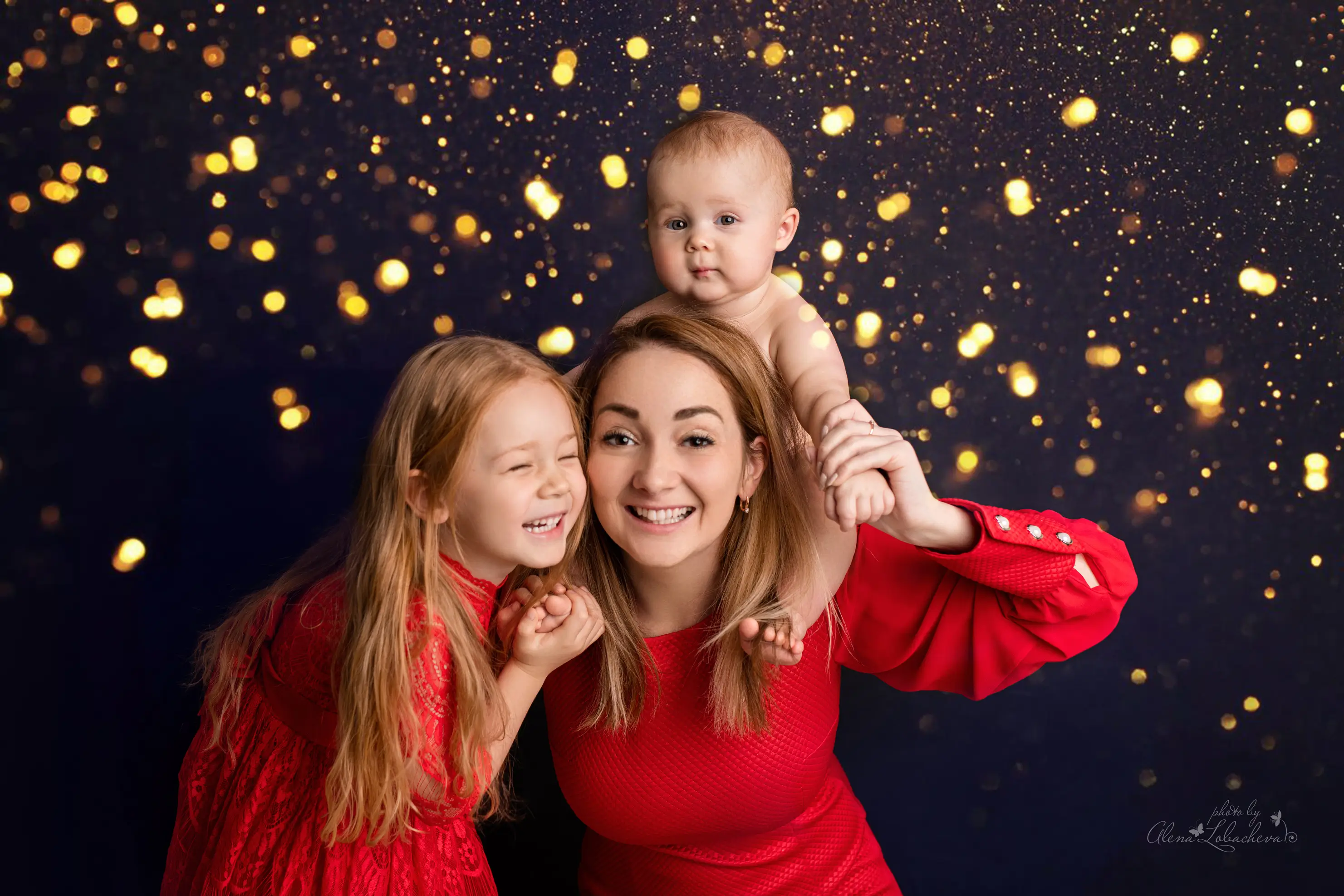 Mother and children wearing coordinated red outfits for holiday portraits